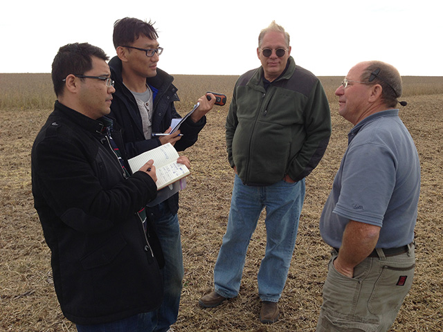 A group of soybean buyers visits the farm of American Soybean Association president Ray Gaesser (right). (DTN Photo by Lin Tan)